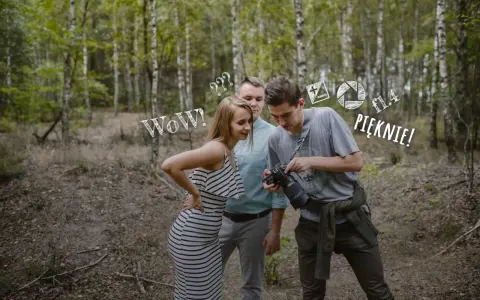 Para zapytań do fotografa ślubnego w lesie. Ona zachwycona, on pokazuje efekt.