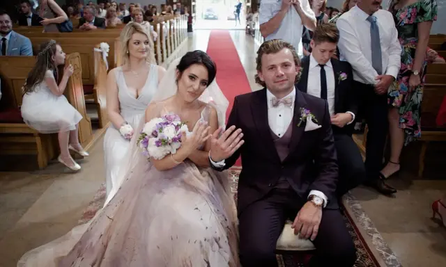 Para młoda podczas ceremonii zaślubin. Panna młoda w pięknej sukni, pan młody w garniturze.