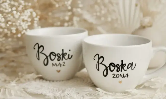Dwie białe filiżanki z napisami "Boski Mąż" i "Boska Żona" - idealne co zamiast kwiatów na ślub cywilny.